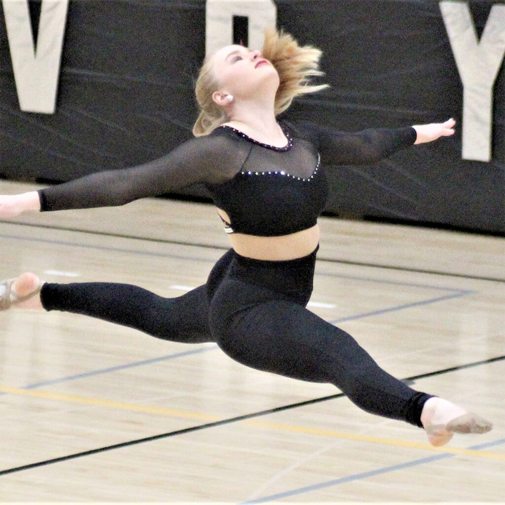 Member of the Voyager squad performing in the high school gym.